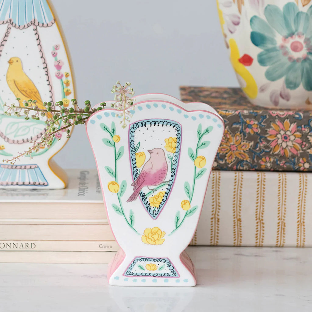 Storybook-like scalloped vase with painted bird and flowers.