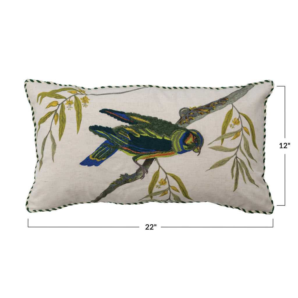 white pillow with blue and green embroidered bird standing on a branch on white background and 22 x 12in dimensions.