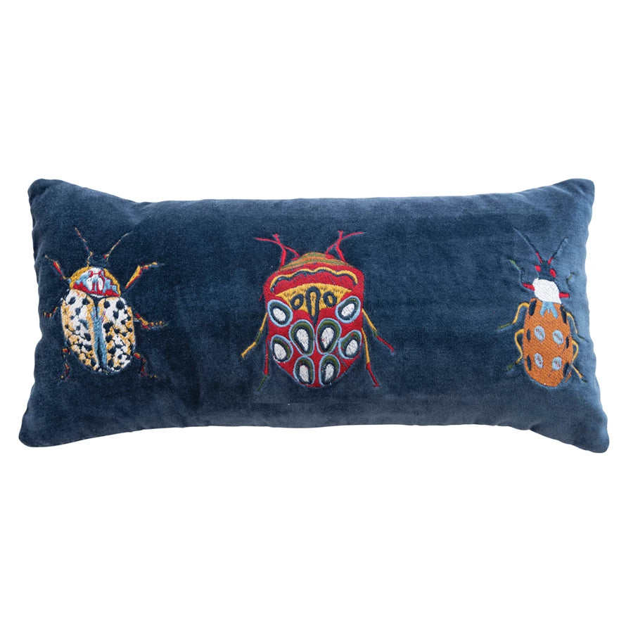 Dark Blue Velvet Lumbar Pillow with 3 Embroidered Beeltes in white, orange, and red tones.
