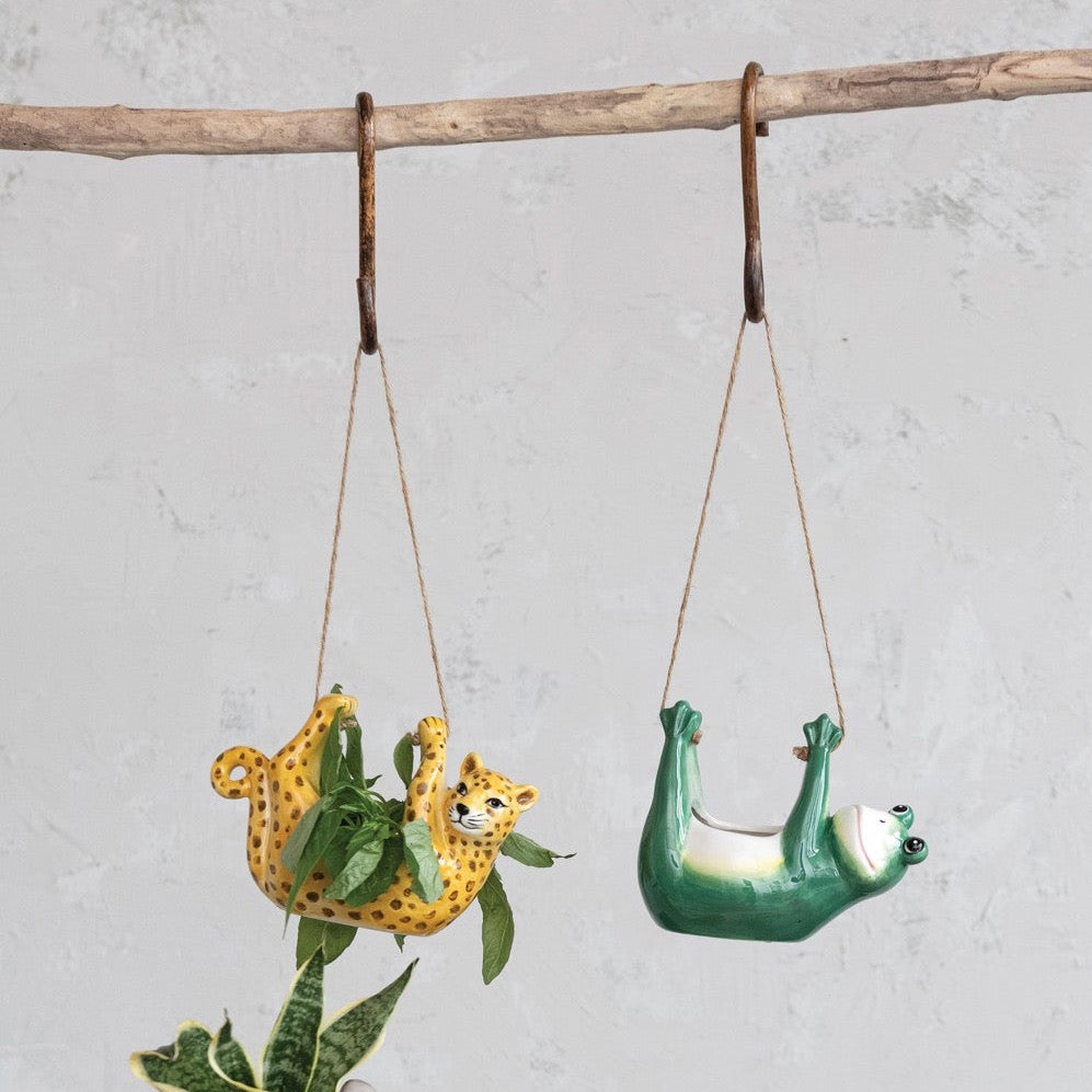 Hanging Ceramic Frog and Leopard Planters with Jute Rope Hangers hanging off hooks on wooden branch