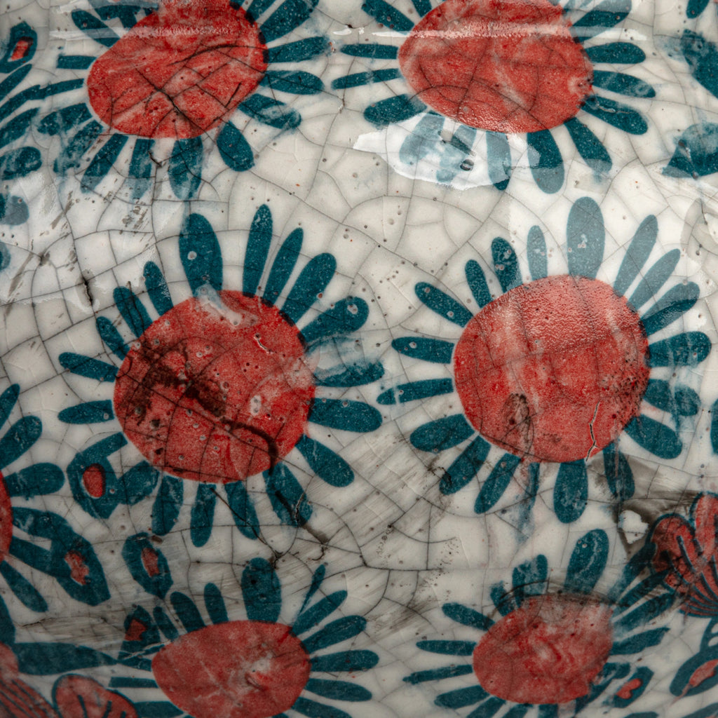 close up of blue and red floral printed footed planter with crackled glaze