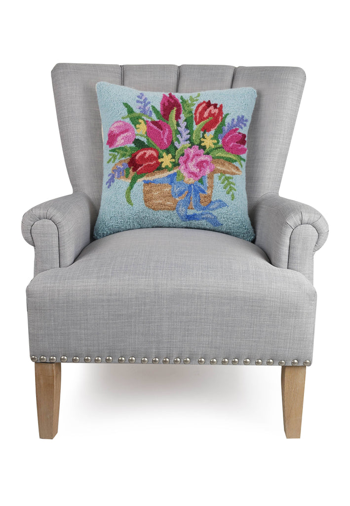 Tulips On Hat basket Hook Pillow on a grey armchair.
