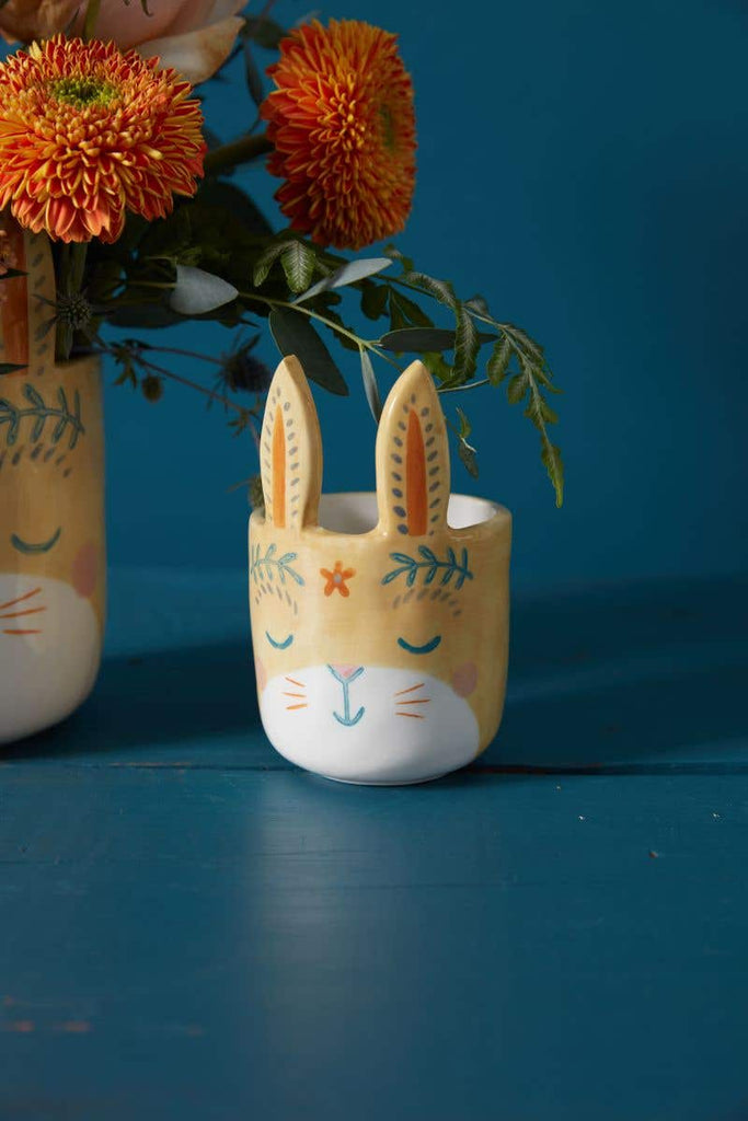Small Frolic Bunny Pot in yellow with flowers and blue background