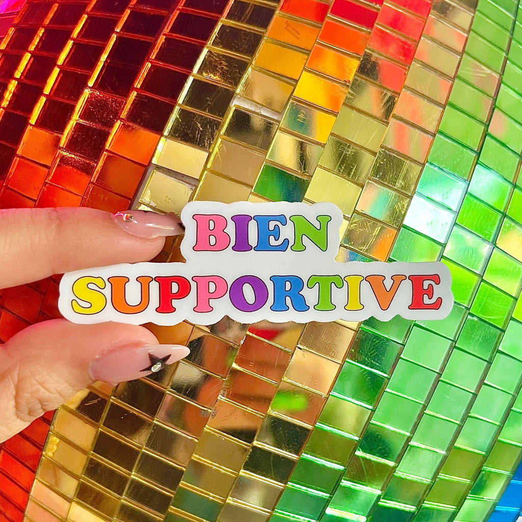 Bien Supportive Sticker in front of rainbow disco ball