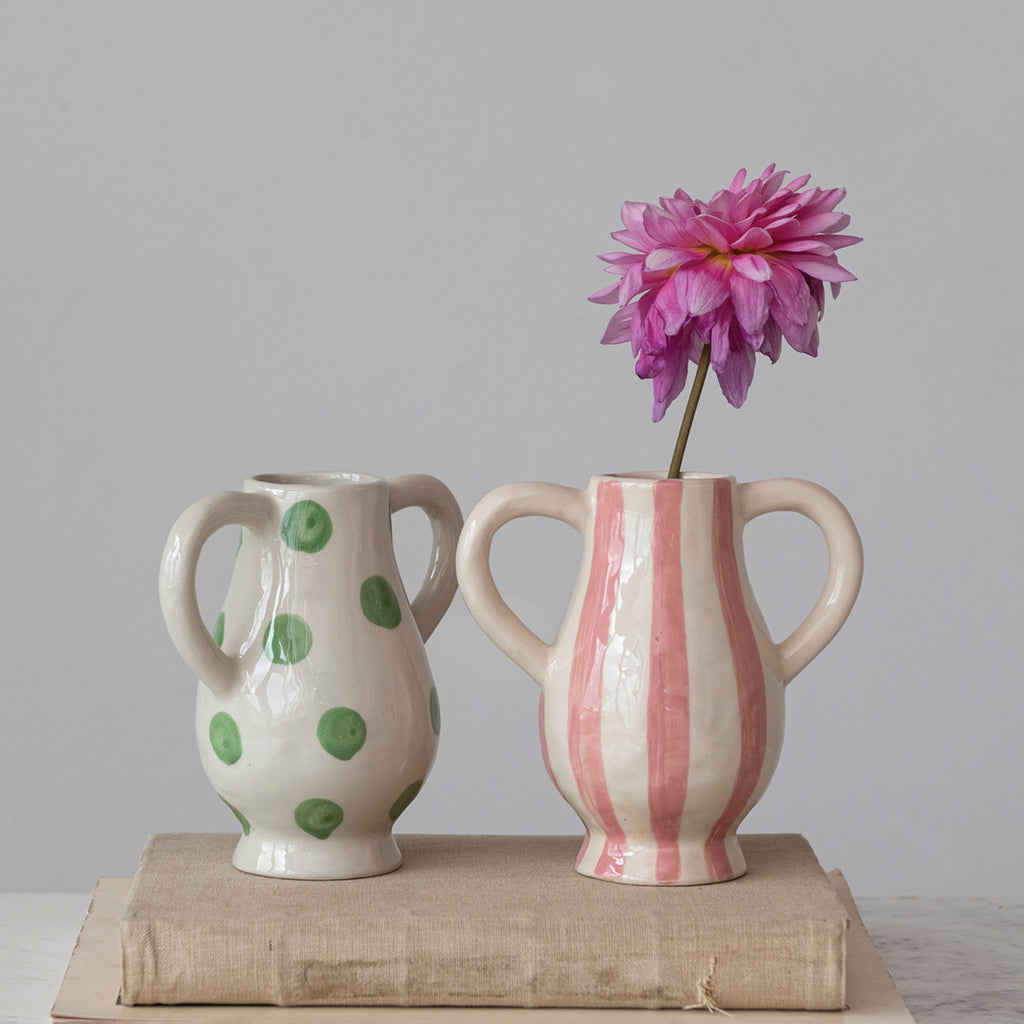 Pink Stripe and Green Polka Dot Hand-Painted Stoneware Vases with Handles shown with pink Dahlia and placed on books with grey background