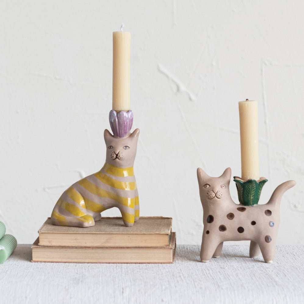 Hand-Painted Stoneware Cat Taper Holder w/ Flower, Yellow Striped cat with purple flowers, and brown polka dot cat with green flower sitting on books holding taper candles.