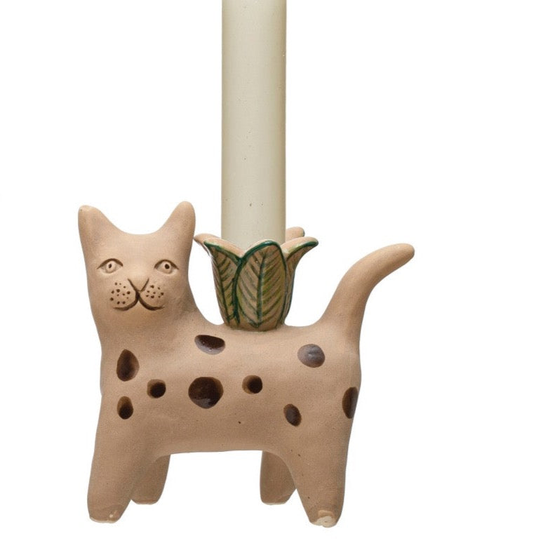 brown polka dot cat with green flower